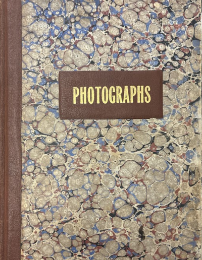 Marbled cover of the T. E. Hecht California Views Photograph Album with the printed title "PHOTOGRAPHS."