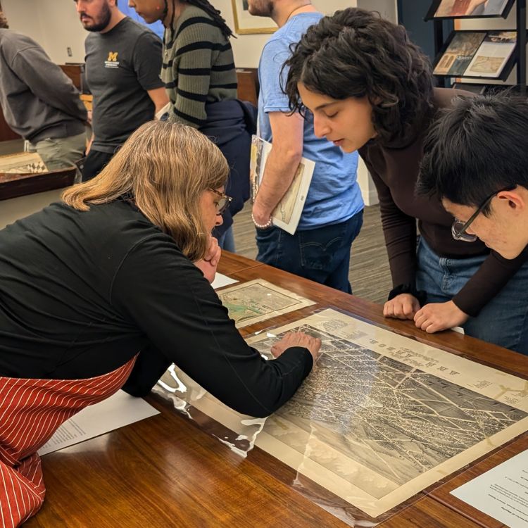 instruction3 Julie Fremuth showing a student details on a print from the Clements collections.