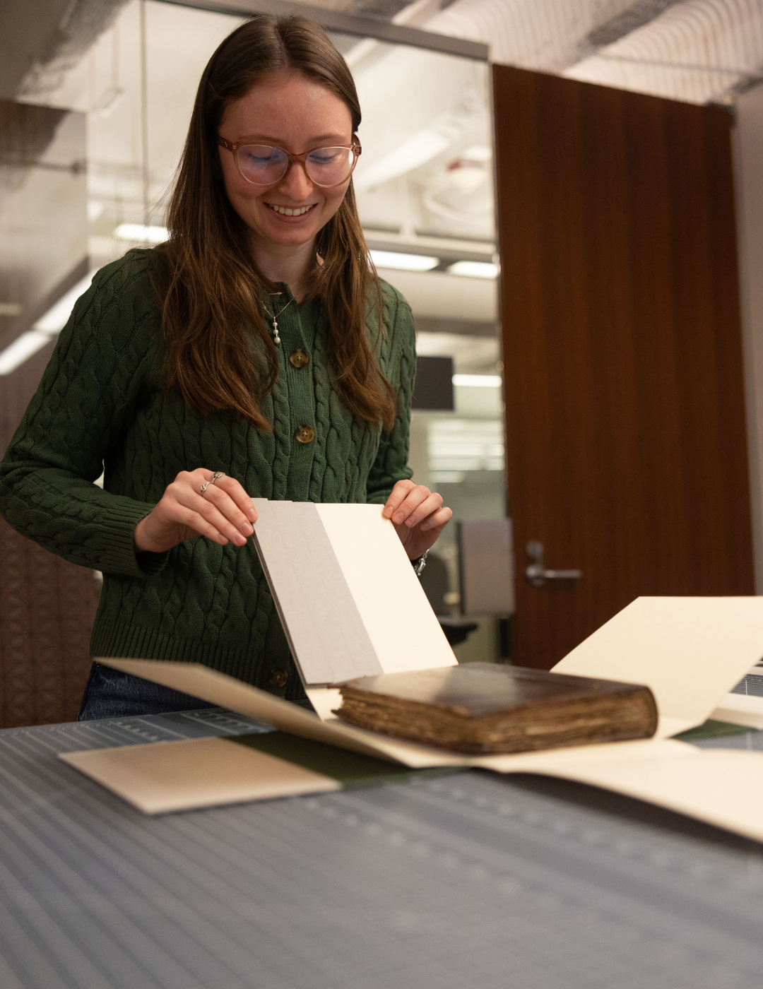 Elli Franklin making a book wrap for a rare book.