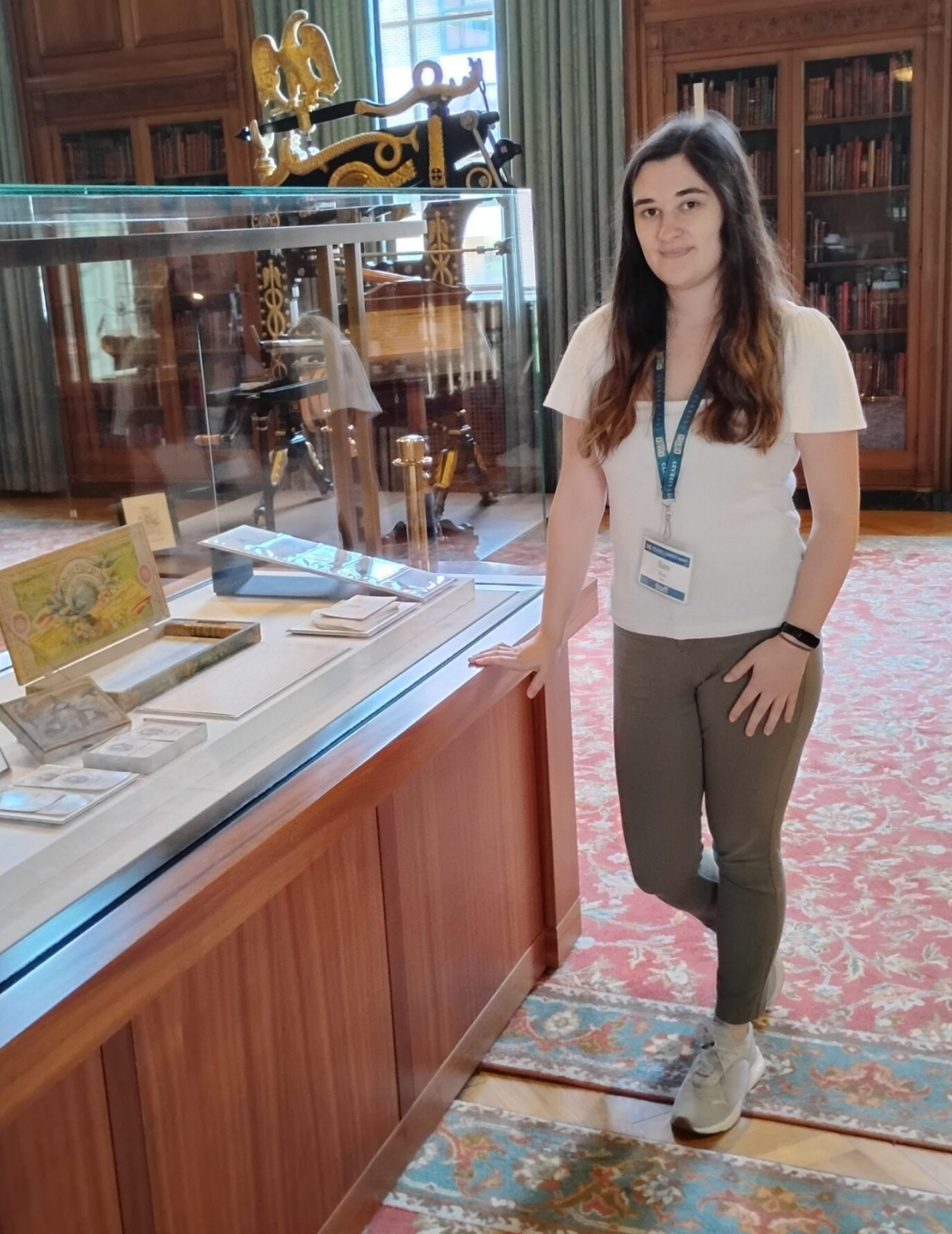 Sam Huck with the "For All Ages" exhibit in the Avenir Foundation Reading Room.