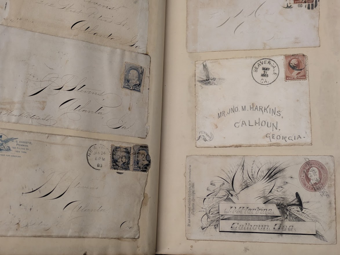 Stevens Portion of J. S. Stevens' collection of fine penmanship and calligraphy. Six envelopes pasted into a scrapbook, one with an illustration of a dove.