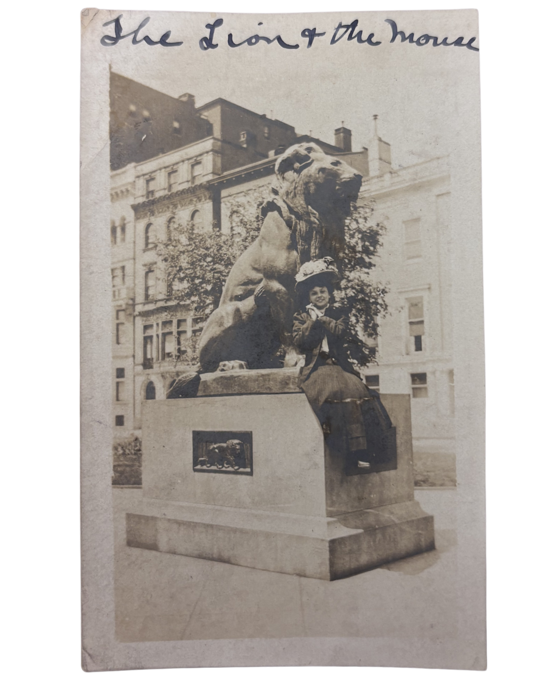 Florence in New York. An undated photograph of Florence in New York City posing with a lion statue. Across the top of the image she wrote "The Lion and The Mouse."