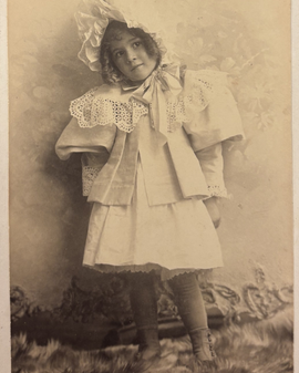 A Young Florence Smith Romaine A young Florence photographed wearing a bonnet and pretty dress.