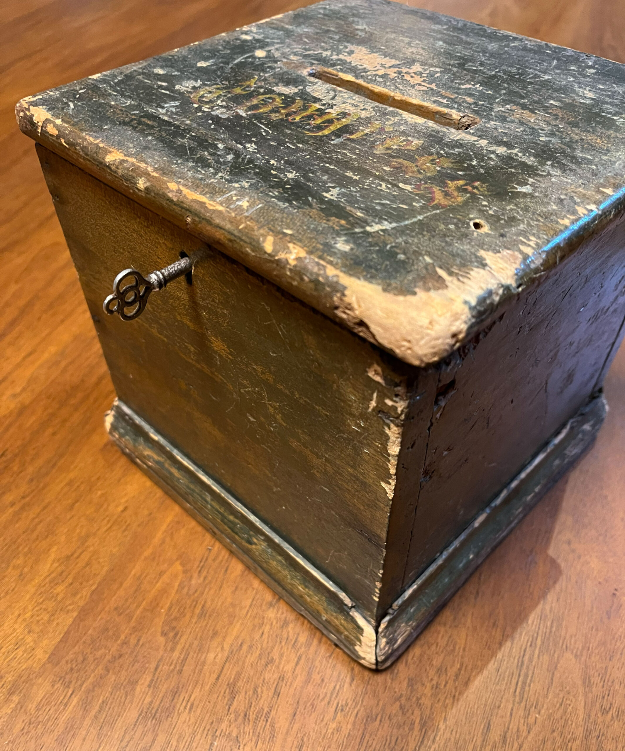 Wooden ballot box with a key in it. The word "CONGRESS" is painted on the top.