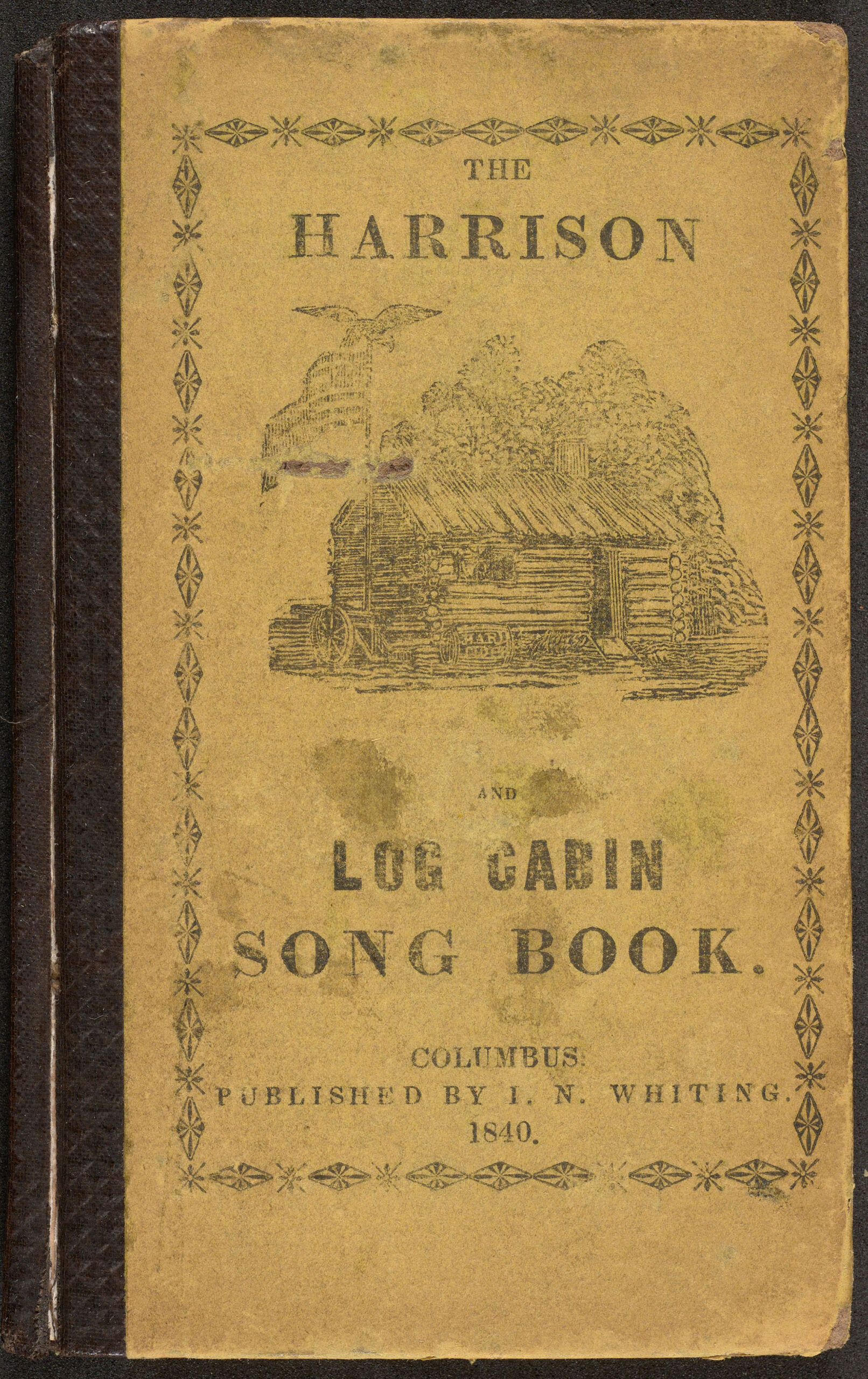 Extra 1 bk-c2 1840 ha-harrison melodies-cover Cover of "The Harrison and Log Cabin Song Book." (1840) Depicts a log cabin with an American flag flying outside, with a bald eagle on top of it.