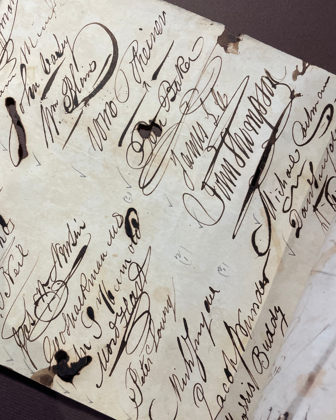signatures Closeup of signatures on a manuscript scroll.